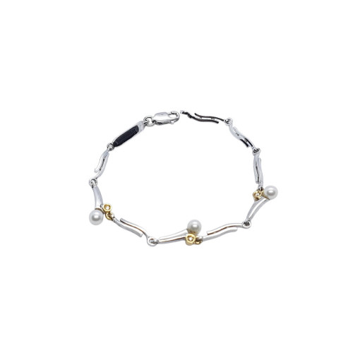 Pulsera maciza y articulada de plata combinada con oro, perlas y diamantes