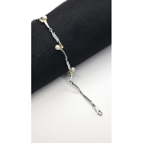 Pulsera maciza y articulada de plata combinada con oro, perlas y diamantes
