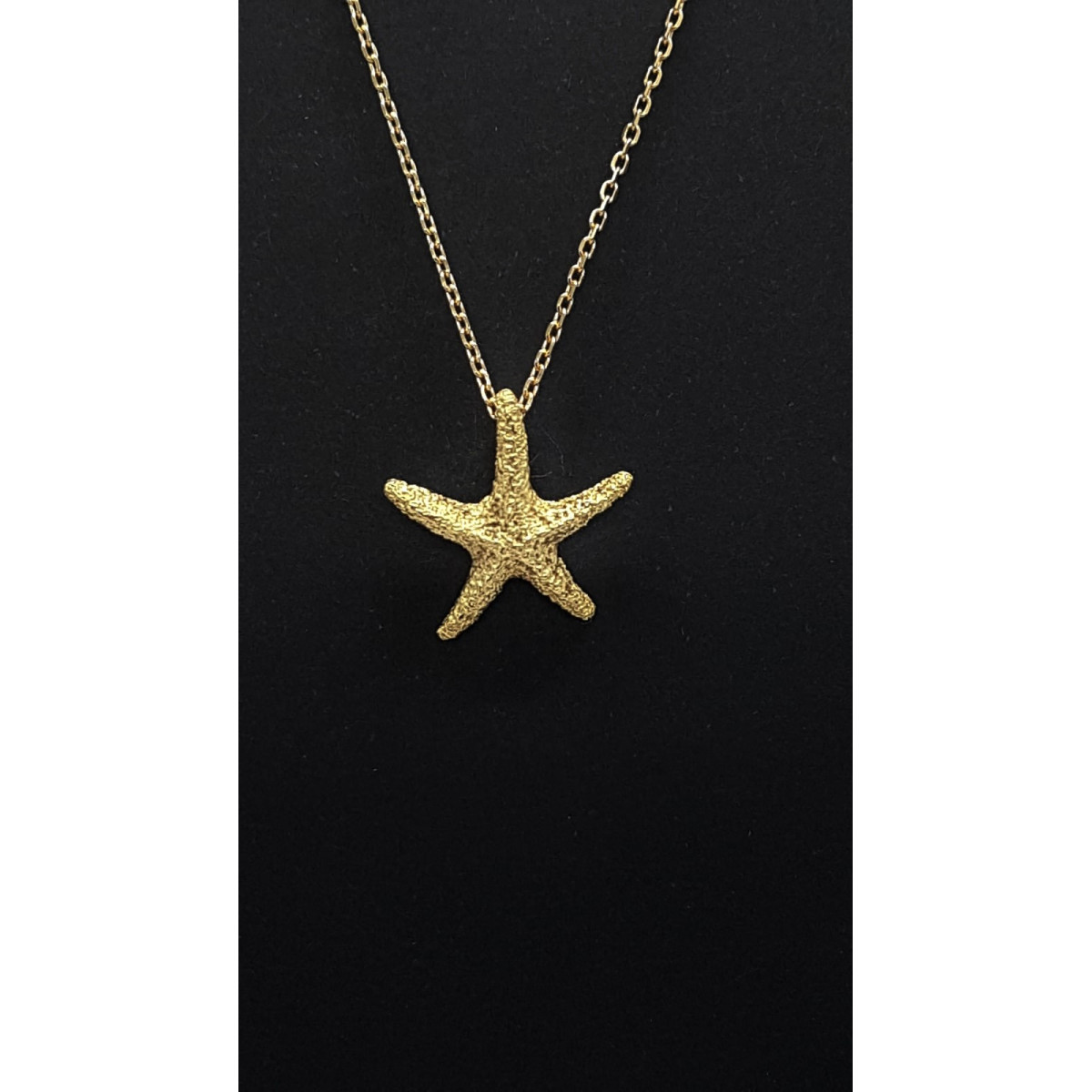 Colgante de oro amarillo con forma de estrella de mar